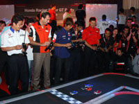(From Left) Mr. Katsuyuki Hiranaka, race driver from Nakajima Racing, Mr. Ralph Firman, race driver of Autobac Racing Team Aguri, Mr. Yuji Ide from Team Kunimitsu and Mr. Toshihiro Kanieshi, race driver from Real Racing with Leon challenging each other in a game of remote-controlled cars.