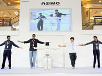 ASIMO demonstrates his flexibility by dancing with the crowd.