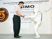 ASIMO's improved abilities to interact with people and serve items, making him a possible assistant in our society.