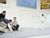 ASIMO plays futsal with the audience.