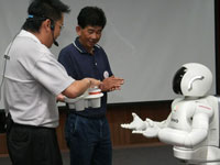 The first beneficiary of the Heart Patients' Fund, Mr Kho Chon Teck is honored to be served by ASIMO during the celebration.