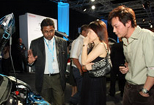 A product specialist explaining the engine specifications of the 2<sup>nd</sup>  Generation Jazz to listening customers.