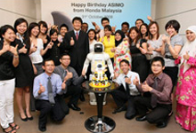 A group photo with ASIMO after celebration.